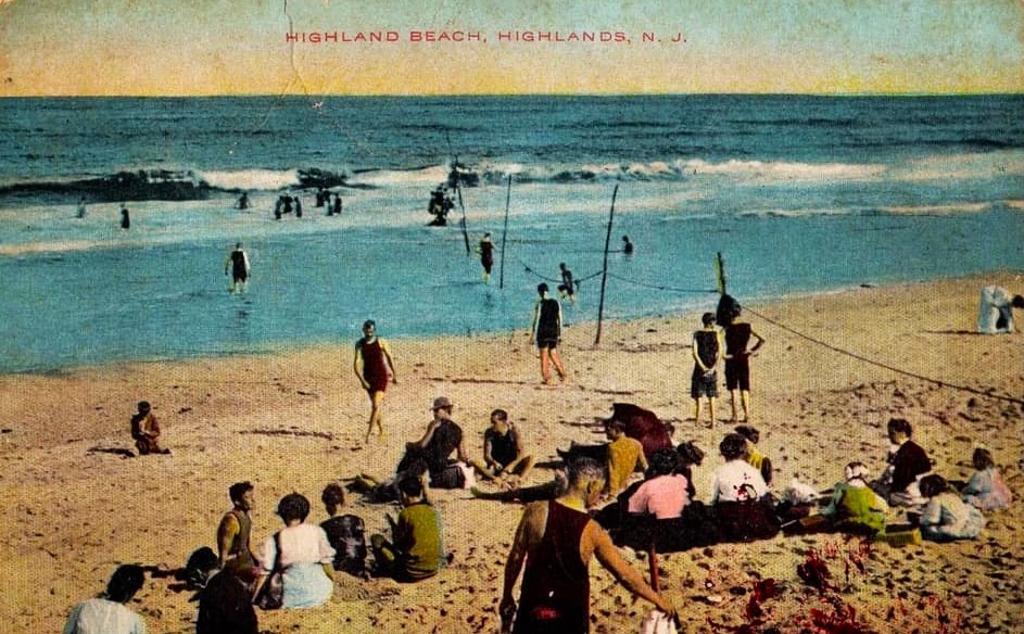 A hand-colored postcard of Highland Beach ca. 1908 titled HIGHLAND BEACH, HIGHLANDS, N. J. — bathers in period costume in the surf, safety rope on posts, spectators on the sand
