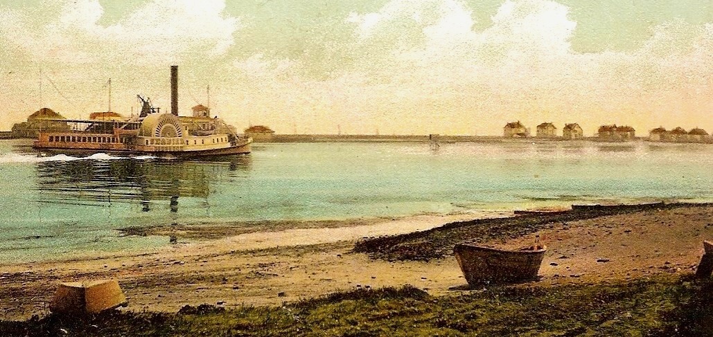 A hand-colored postcard ca. 1910 of a Central RR of New Jersey Sandy Hook Steamer passing Highland Beach — a large wooden side-wheel steamer with a tall single stack, a beached rowboat at right, the Highland Beach cottage row on the far shore