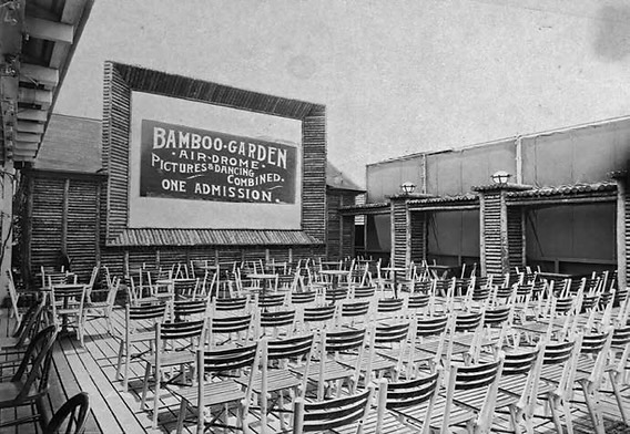 A small-format print of the Bamboo Garden Airdrome interior — same as IMG_8483, showing the projection screen with signage reading BAMBOO-GARDEN AIR-DROME · PICTURES & DANCING COMBINED · ONE ADMISSION and rows of wicker folding chairs on a wooden deck
